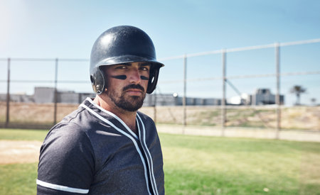 Battling it out at the ballpark. Portrait of a young man playing a game of baseball.の写真素材