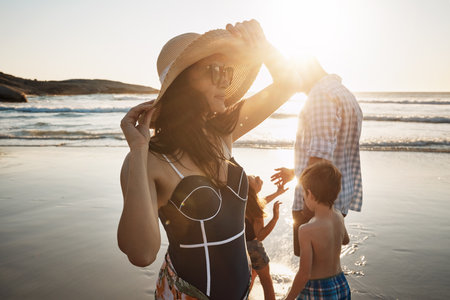 Im so ready for this day. a family of four spending the day at the beach.の写真素材