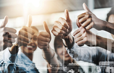 Take pride in all that you do. Closeup shot of a group of businesspeople showing thumbs up in an...