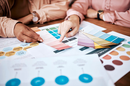 Creative business people, hands and color palette in planning, brainstorming or team strategy on...