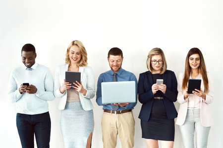 Group, wall or business people with technology connection for hiring, vacancy recruitment or job interview. Digital, women or happy men on white background waiting room for startup company onboardingの写真素材