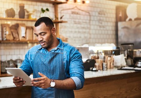 Search, tablet and manager with man in cafe for online, entrepreneurship and startup. Waiter, technology and food industry with small business owner in restaurant for barista, network and coffee shopの写真素材