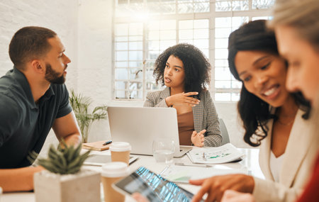 Businesspeople collaborating. Group of diverse architects in a meeting. Businesswoman speaking to a...