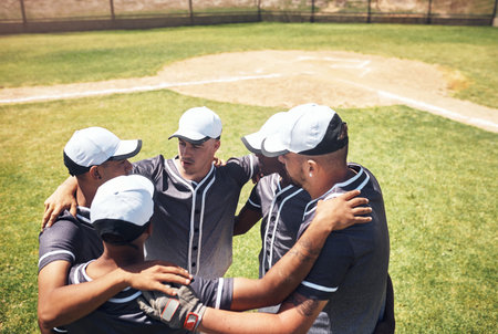 Its where winners are made. a group of young men huddled together at a baseball game.の写真素材