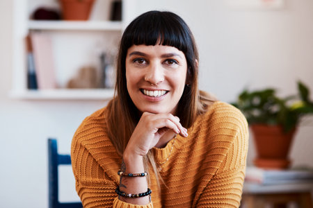 I just love spending quality time with myself. an attractive young woman relaxing at home.の写真素材