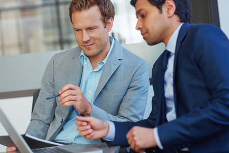 They make a great team. businessmen working in their office.の写真素材