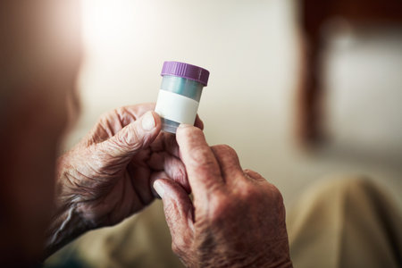 How many should I take per day. an unrecognizable senior man about to take his medication.の写真素材