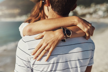 Summertime is romancing time. an affectionate young couple kissing while embracing on a summers day outdoors.の写真素材