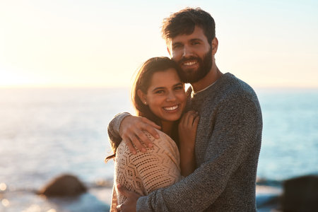 True love is real, we found it. Portrait of a young couple sharing an affectionate moment on the beach at sunset.の写真素材