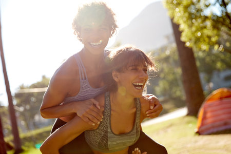 Laughing is good exercise. a sporty young couple spending the day outdoors.の写真素材