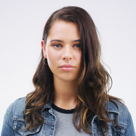 Face, serious portrait and a woman in studio with healthy skin, natural beauty and cosmetics. Headshot of a young female model with a facial expression isolated on a white background from Canadaの写真素材