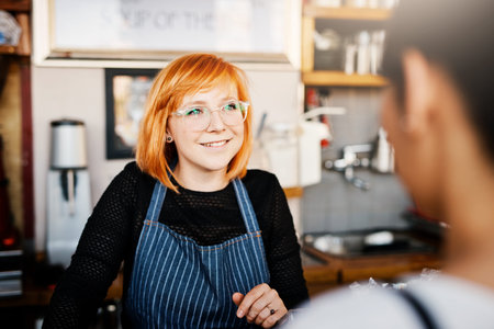 She loves working with people. a shop assistant helping a customer.