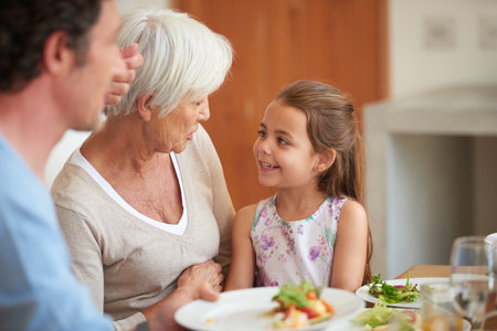 Her granddaughter makes her so happy. a multi-generational family having lunch together.の写真素材