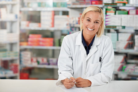 Choose a pharmacist you trust. Portrait of a pharmacist working in a drugstore. All products have been altered to be void of copyright infringements.の写真素材