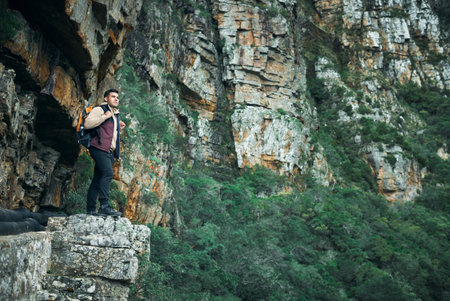 Fill your life with stories to tell, not things to show. a young man standing on a cliff while out...