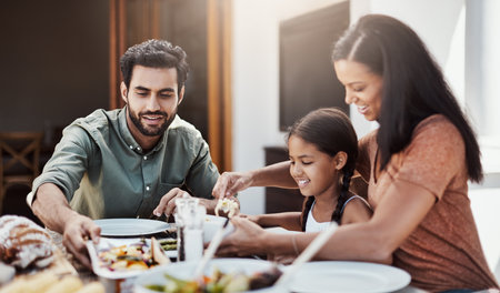 Its a time to eat and a time to bond. a happy young family enjoying a meal together outdoors.の写真素材