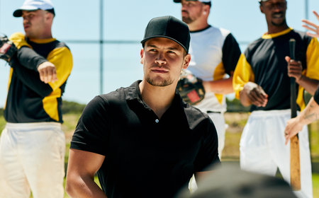 Coaching is his calling. a handsome young baseball coach looking thoughtful while standing on the...