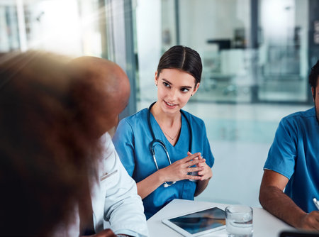 Everyones voices gets heard. a group of focused young doctors having a discussion together while...
