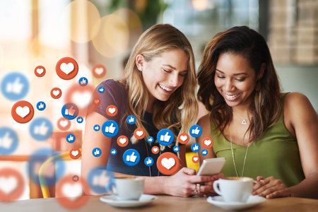 Cafe, social media icon or women with phone for communication, text post or online dating chat. Coffee, girls or happy friends on mobile app website or digital network with smile, like or heart emojiの写真素材