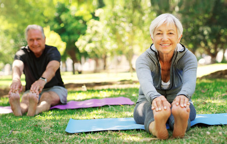 Portrait, fitness and senior couple in a park, yoga and meditation for wellness, workout and healthy lifestyle. Face, mature woman or old man outdoor, stretching and exercise for balance or fresh airの写真素材