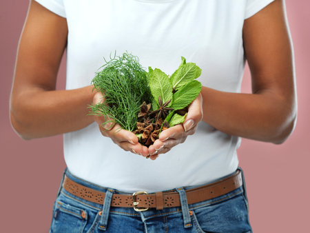 Flavour for your food. a woman holding a variety of herbs.の写真素材