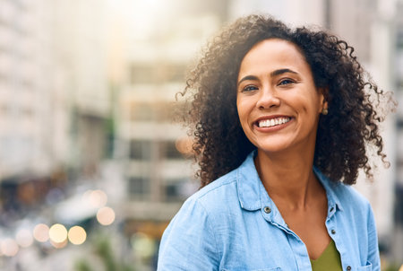Happy, smile and portrait of woman in city with happiness, freedom and confidence in urban town. Traveling, face and confident and African female person on weekend, holiday and relax in South Africaの写真素材
