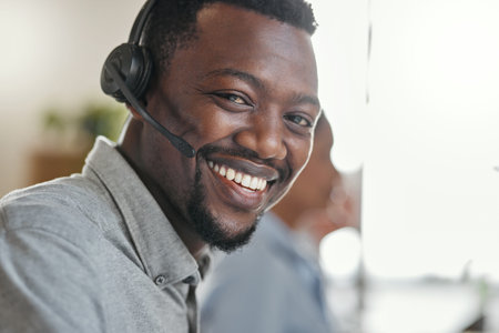 Need help Call our hotline. Portrait of a young man using a headset in a modern office.