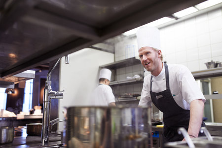 Commercial, man and chef in a kitchen, service and order preparation for meal during dinner rush....