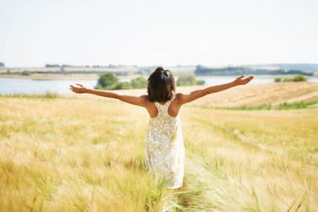 Enjoying the countryside. a woman in a wheat field.の写真素材