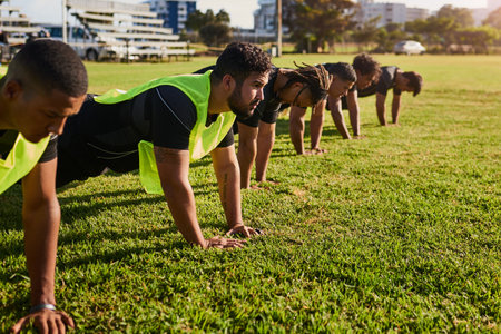 Building core strength. a diverse group of sportsmen training during a rugby practice in a sports club.の写真素材