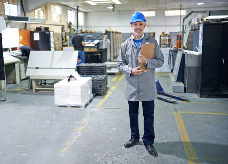 Your one stop for printing start to finish. Portrait of a manager standing inside of a printing and packaging factory.の写真素材