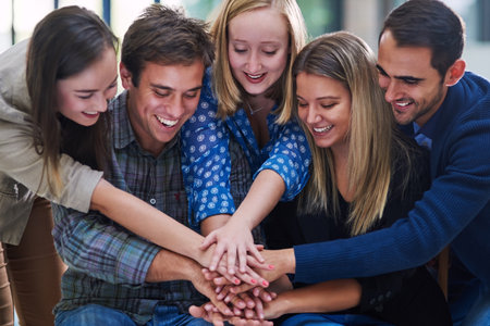 Happy, people and hands stack in support of success, goals and trust of mission, cooperation and synergy. Motivation, hand and group collaboration of teamwork, achievement and celebrate solidarityの写真素材