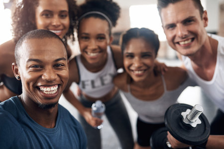The best buddies are gym buddies. a group of young people taking a selfie together during their workout in a gym.の写真素材