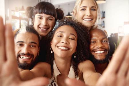 A good time is guaranteed when theyre around. a group of young friends taking selfies together at a restaurant.の写真素材