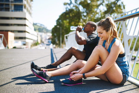 On the road to fitness. two young people getting ready for their run.の写真素材