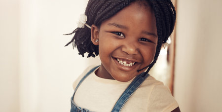 I think its time to go play now. Portrait of an adorable little girl feeling cheerful and happy at home.の写真素材