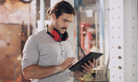 Tablet, industry and planning with a man in a workshop for manufacturing, production or metal work....