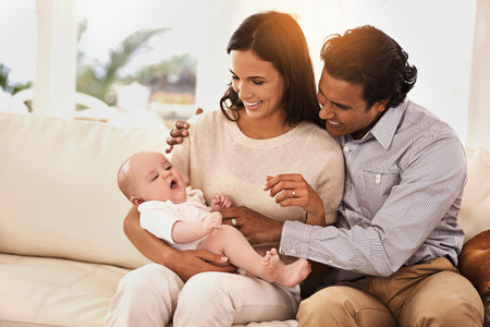 When your family grows, so does the love. an affectionate couple and their newborn baby.
