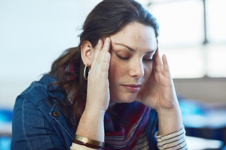 Theres just too much info to cram in. a university student looking stressed out at campus.の写真素材