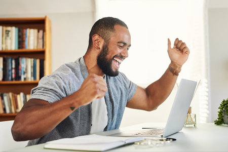 Ive never felt happier. a handsome businessman looking excited while working from home.の写真素材