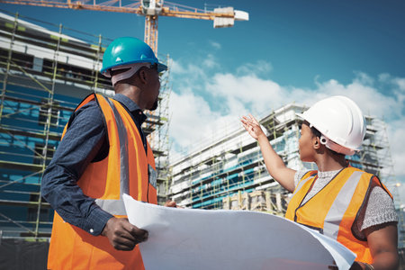 Blueprint, engineer or architect team talking outdoor about building project, construction or...