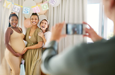 Celebrating with my closest friends. a group of women taking photos at their friends baby shower.