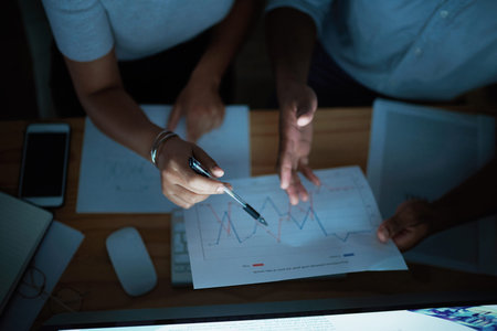 Tonight, we talk money. unrecognisable businesspeople analysing financial reports during a late...