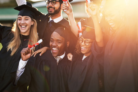 Take pride in how far youve come. a group of cheerful university students on graduation day.の写真素材