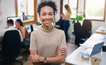 Woman, happy and portrait of designer with arms crossed in office workplace for business. Face, confidence and graphic design, African female person or creative entrepreneur, professional and successの写真素材