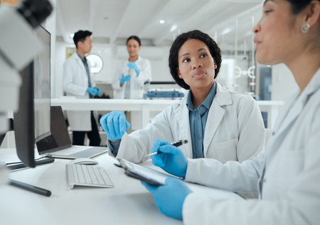 What do you think. two scientists helping one another in the lab.の写真素材
