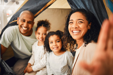 Selfie, home camping and happy family portrait, bonding and smiling together on vacation in Brazil holiday house. Memory photo, youth childhood or cheerful children, mother and father playing in tentの写真素材