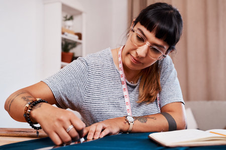 I have to make sure that I stay on this line. a young woman making a garment at home.の写真素材