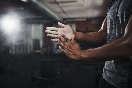 The power is in your hands. an unrecognizable man dusting his hands with talcum powder.の写真素材
