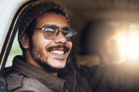 Hop in and lets go. Portrait of a happy young man sitting in a rusty old truck.